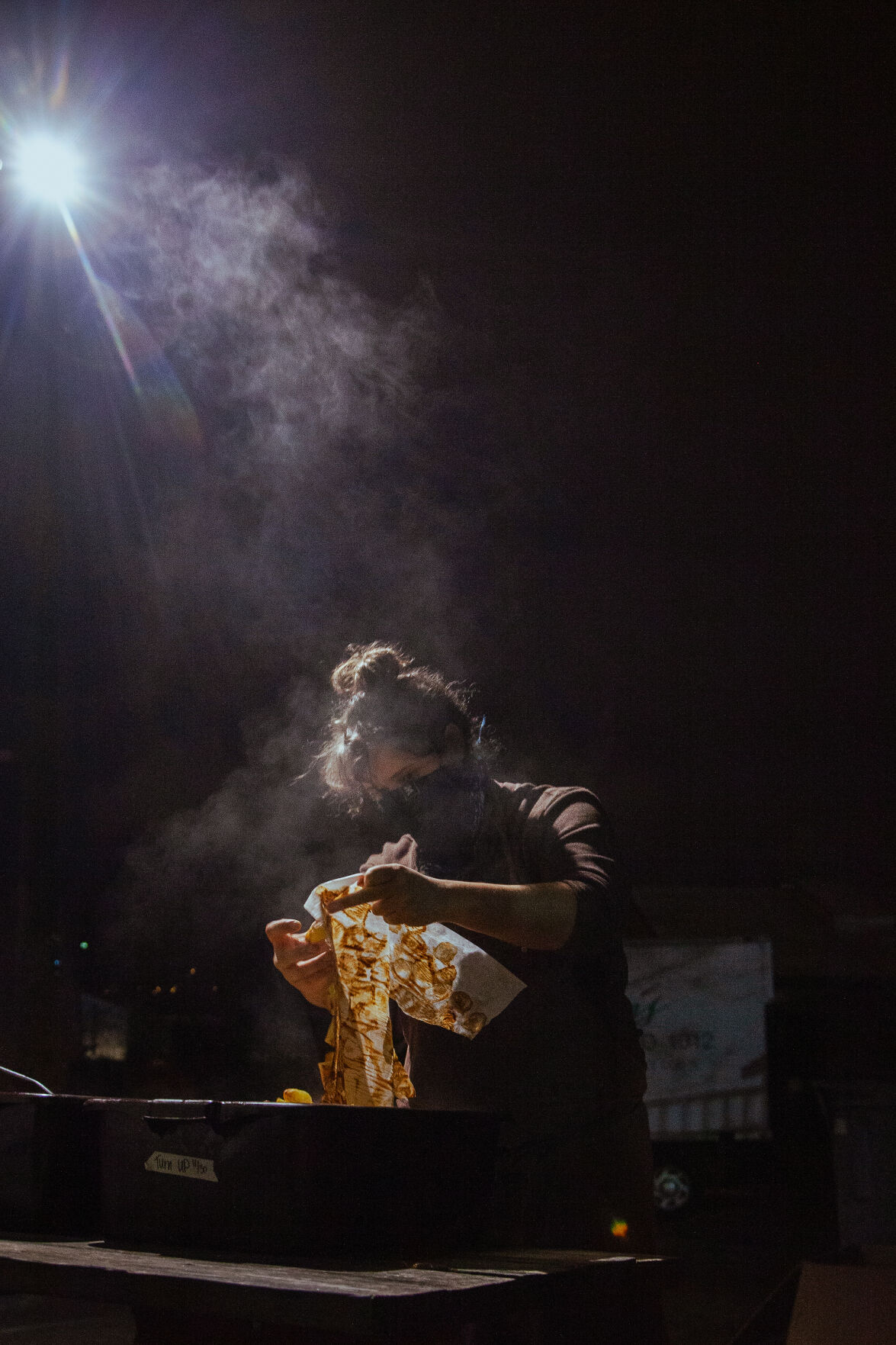 Michelle La Fata dumps roasted potatoes in a bin